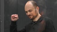 Vladimir Kara-Murza gestures standing in a glass cage in a courtroom during announcement of the verdict on appeal at the Moscow City Court in Moscow, Russia, on July 31, 2023.