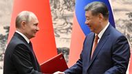 Russian President Vladimir Putin and Chinese President Xi Jinping exchange bilateral documents during a meeting in Beijing, China. Pic: Sputnik/Sergei Bobylev/Pool via Reuters