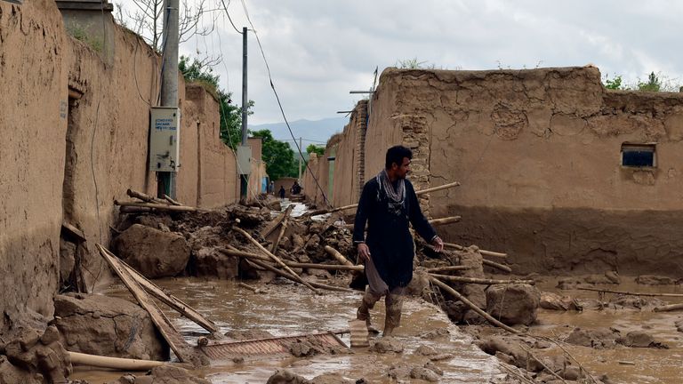 An Afghan man walks near his damaged home after heavy flooding in Baghlan province in northern Afghanistan Saturday, May 11, 2024. Flash floods from seasonal rains in Baghlan province in northern Afghanistan killed dozens of people on Friday, a Taliban official said. (AP Photo/Mehrab Ibrahimi)