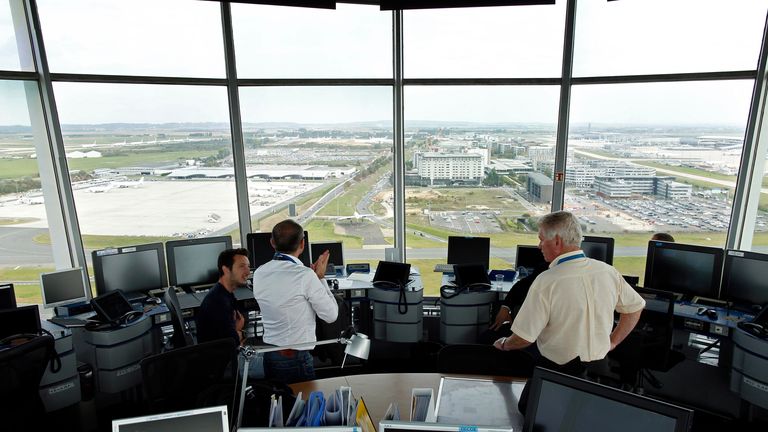 An air-traffic controller (R) speaks with visitors in the main control tower at the Charles de Gaulle International Airport in Roissy, near Paris on the third day of an Air France one-week strike September 17, 2014. The French government called for an end to the Air France pilots strike, now in its third day, as the dispute over cost cuts threatened 60 percent of the airline&#39;s flights on Wednesday. The pilots are carrying out a week-long strike over the airline&#39;s plans to expand the low-cost ope