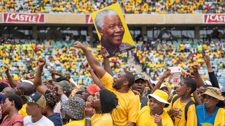 African National Congress supporters hold up a portrait of Nelson Mandela at the manifesto launch in February. Pic: AP