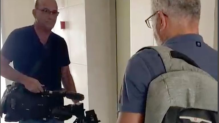 In this image from video, Israeli officials seize AP video equipment from an apartment block in Sderot, Southern Israel, Tuesday, May 21, 2024. Israeli officials seized the camera and broadcasting equipment belonging to The Associated Press in southern Israel on Tuesday, accusing the news organization of violating the country's new ban on Al Jazeera. Shortly before the equipment was seized, it was broadcasting a general view of northern Gaza. (AP Photo/Josphat Kasire)