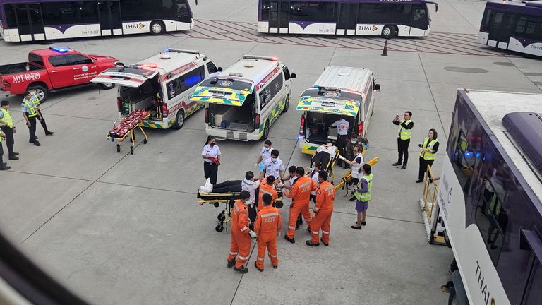 Staff member carry people on stretchers after an emergency landing at Bangkok&#39;s Suvarnabhumi International Airport, in Bangkok.
Pic Reuters