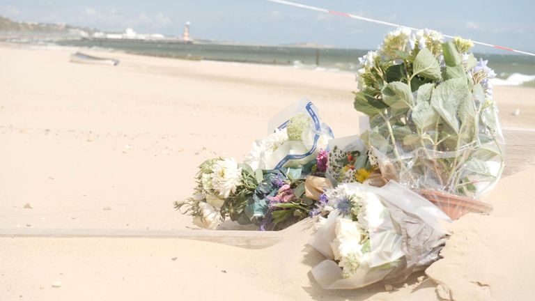 Flowers left on the beach were two women were stabbed