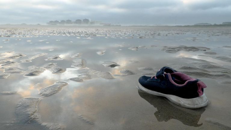 A shoe left in the sand after migrants cross the Channel for the UK