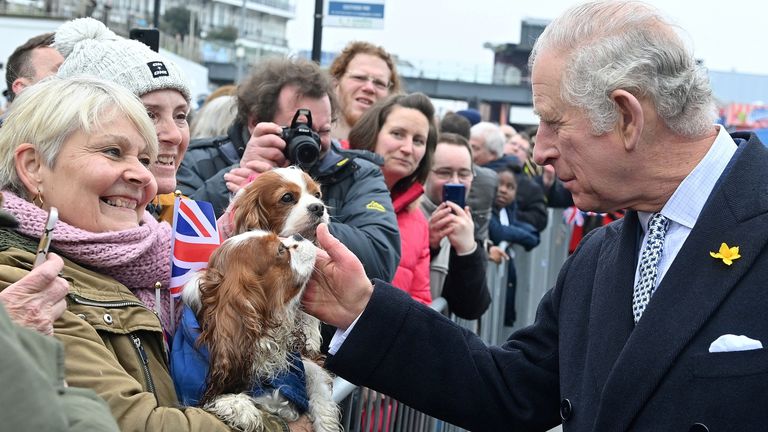 Britain&#39;s Prince Charles strokes a member of the public&#39;s dog outside the Pier during his visit to the Pier in Southend-on-Sea, Britain March 1, 2022. Justin Tallis/Pool via REUTERS