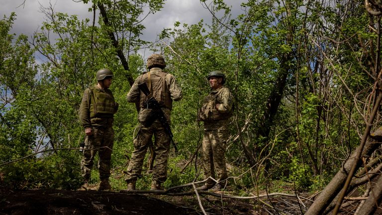 Ukrainian servicemen of the 22nd Separate Mechanised Brigade stand near an artillery position, amid Russia's attack on Ukraine, on the outskirts of Chasiv Yar, Ukraine, April 19, 2024. REUTERS/Thomas Peter