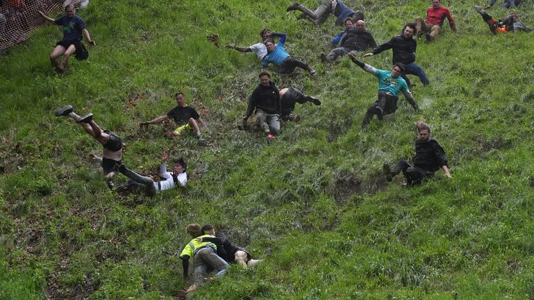 Pic: PA Participants take part in the annual cheese rolling at Cooper's Hill in Brockworth, Gloucestershire. Picture date: Monday May 27, 2024.