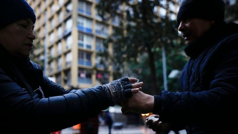 A vendor hands a customer a cup of coffee in Santiago, Chile 17 May 2024. Pic: AP