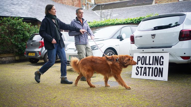 Cinna, an 8-year-old rescue dog from Greece, arrives with owners to the polling station at St Alban&#39;s Church in London.
Pic: PA
