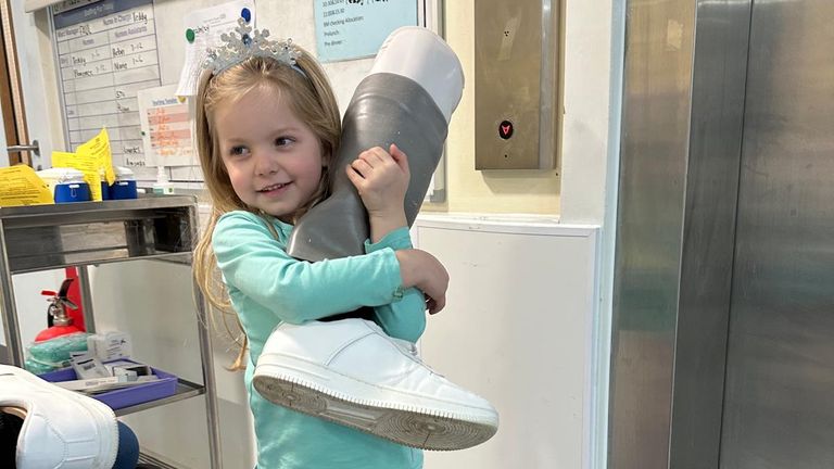 Craig&#39;s daughter Olivia with one of his artificial limbs Pic: Katalin Mackinlay