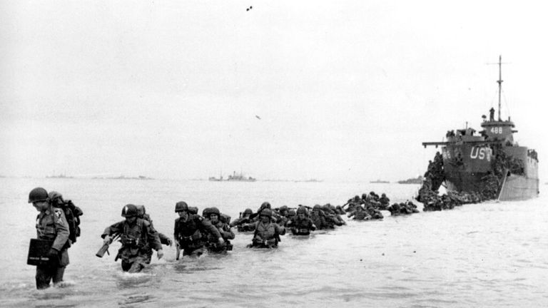 US reinforcements wade through the surf in the days following D-Day. Pic: Bert Brandt/AP
