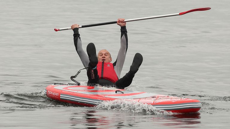 Photo: Reuters British Liberal Democrat party leader Ed Davey falls from a paddle board into Lake Windermere, in Windermere, Great Britain, May 28, 2024. REUTERS/Phil Noble