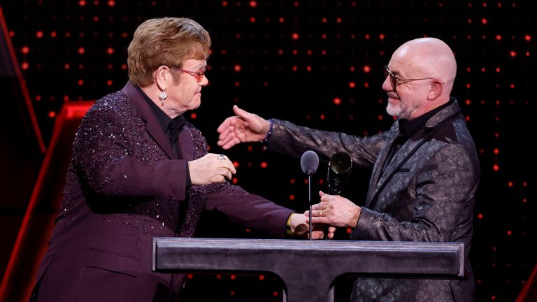 Bernie Taupin receives the Musical Excellence Award from Elton John during the 38th Annual Rock & Roll Hall of Fame Induction Ceremony in Brooklyn, New York, U.S., November 3, 2023. REUTERS/Eduardo Munoz