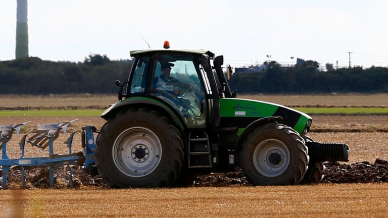 A farmer ploughs a field in front of wind turbines in Mablethorpe, east England September 7, 2013. REUTERS/Darren Staples (BRITAIN - Tags: AGRICULTURE ENERGY ENVIRONMENT)