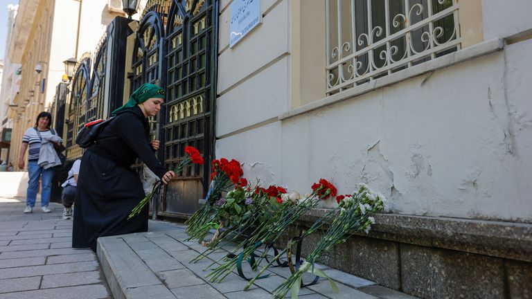 A woman brings flowers to the Iranian embassy to pay tribute to Iran&#39;s President Ebrahim Raisi, Foreign Minister Hossein Amirabdollahian and other victims in Moscow.
Pic: Reuters