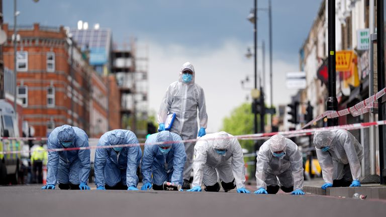 Police forensic officers on Kingsland High Street.
Pic PA