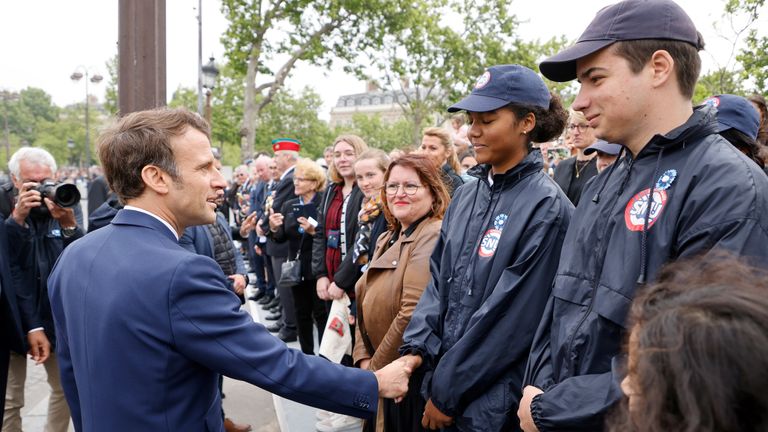 France&#39;s President Emmanuel Macron greets members of the Universal National Service (Service national Universel, SNU) at the Arc de Triomphe as part of the ceremonies marking the victory against the Nazis and the end of the World War II in Europe (VE Day), in Paris, France, May 8, 2022. Ludovic Marin/Pool via REUTERS
