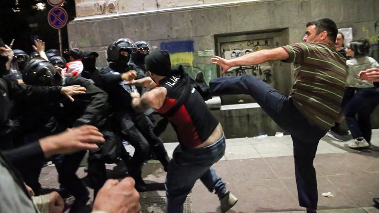 Demonstrators scuffle with riot police. Pic: AP