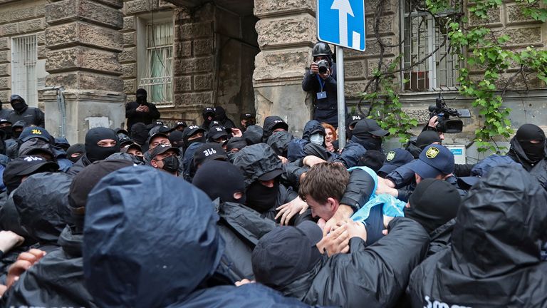 Law enforcement officers detain a demonstrator during a protest against a bill on 'foreign agents' in Tbilisi. Pic: Reuters 
