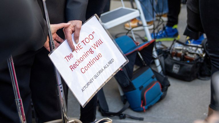 Mimi Haley's attorney, Gloria Allred, holding a sign before speaking to reporters outside the courthouse.  Photo: Reuters