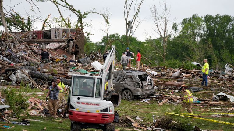 Workers search through the remains of tornado-damaged homes, Tuesday, May 21, 2024, in Greenfield, Iowa. (AP Photo/Charlie Neibergall)