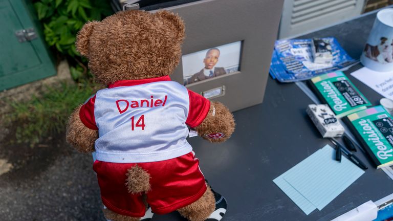 A teddy bear in an Arsenal top on a table at the vigil. Jeff Moore/PA