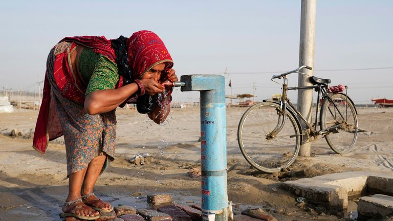 A woman drinks from public tap in India. Pic: AP