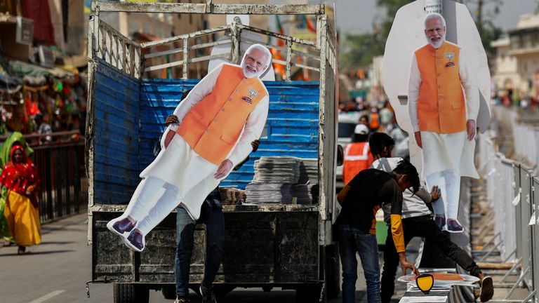 A person carries a cut-out of Modi, ahead of his election campaign rally, in Ayodhya, over the weekend. Pic: Reuters