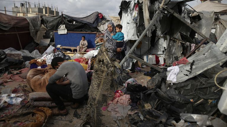 Displaced Palestinians inspect their tents destroyed by Israel's bombardment west of Rafah. Pic: AP