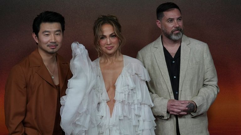 Simu Liu, left, Jennifer Lopez, center, and Brad Peyton pose for photos in a promotional event for Netflix series ATLAS in Mexico City, Tuesday, May 21, 2024. (AP Photo/Marco Ugarte)