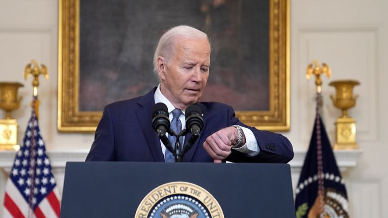 President Joe Biden checks his watch before delivering remarks on the verdict in former President Donald Trump's hush money trial and on the Middle East, from the State Dining Room of the White House, Friday, May 31, 2024, in Washington. (AP Photo/Evan Vucci)