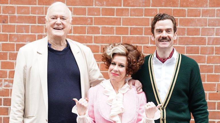 (Left to right) John Cleese with Anna-Jane Casye as Sybil, and Adam Jackson-Smith as Basil Fawlty. Pic: PA
