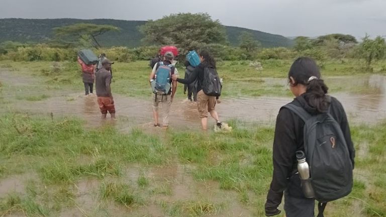 Tourists who chose to remain in the reserve walk through a flooded field. Pic: James Apolloh Omenya 