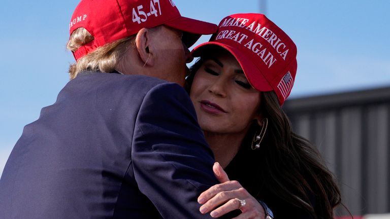 Kristi Noem and Donald Trump hug at a campaign rally in South Dakota.  Image: AP