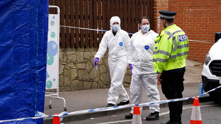 Police officers and forensic officers by a forensic tent at the scene in Luton.
Pic: PA