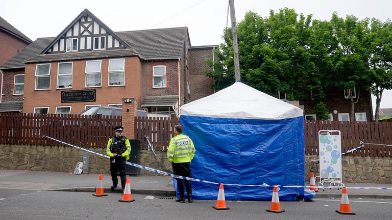 Police officers by a forensic tent n Luton.
Pic: PA