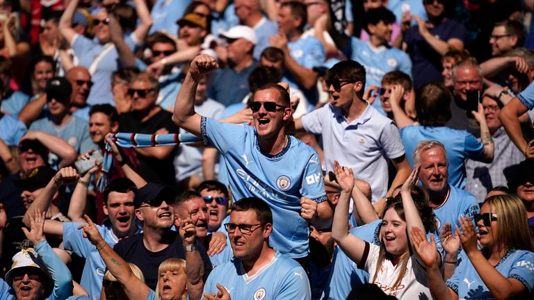 Fans celebrate after Manchester City's Phil Foden scores his side's second goal. Pic: AP