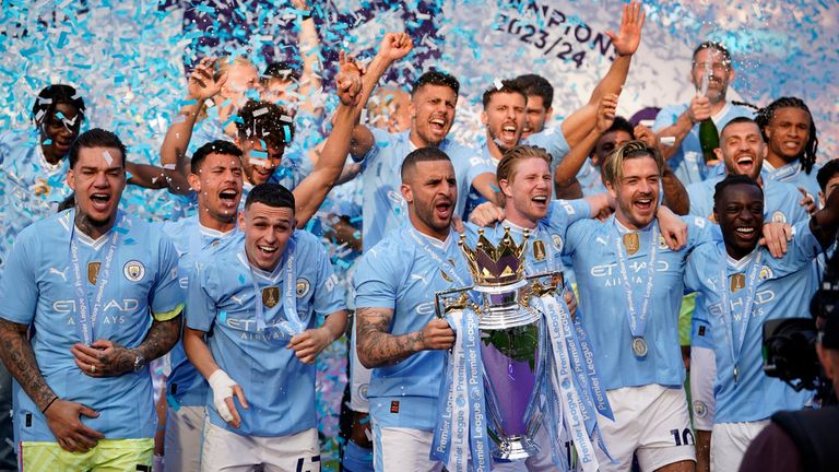 Man City players celebrate with the Premier League trophy. Pic: AP