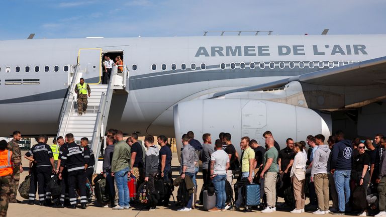 Civil guards, police officers and sailors firefighters line up as they board a plane of the French Air Force at Istres military airbase after France declared a state of emergency to regain control of events in New Caledonia, near Marseille, France, May 16, 2024. REUTERS/Manon Cruz
