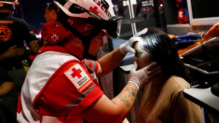A Mexican Red Cross rescuer gives a girl treatment. Pic: Reuters