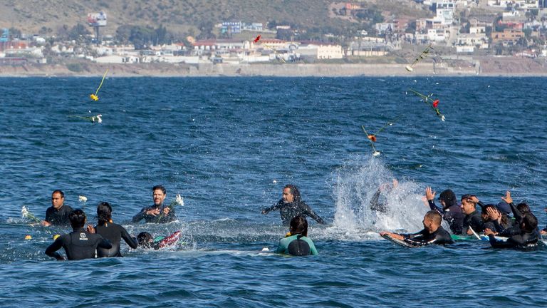 Surfers near in Ensenada threw flowers in a tribute to the men. Pic: AP
