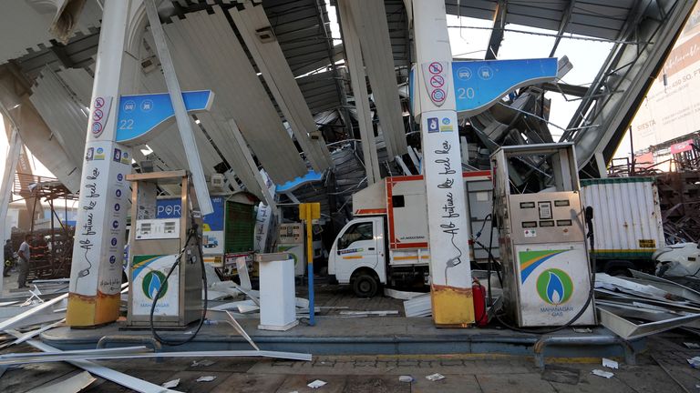 The billboard fell on a petrol station. Pic: Reuters
