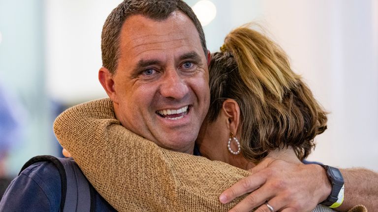 Chris Salmon is greeted by his wife after arriving from New Caledonia into Brisbane International Airport, in Brisbane, Australia,  
Pic: AAP/AP