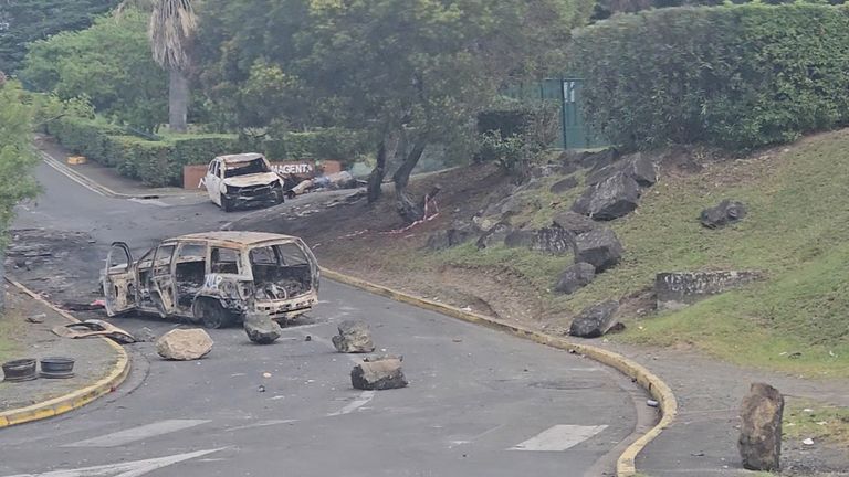 A view of burnt cars on a road in Noumea, New Caledonia.
Pic:  @ericpaidjan/Reuters