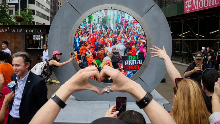 New Yorkers greet people in Dublin during the reveal of The Portal in New York City, U.S., May 8, 2024. Pic: Reuters 
