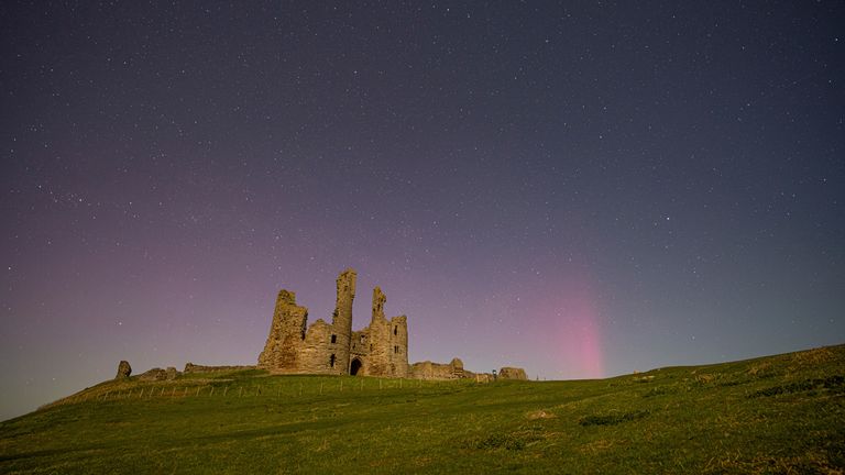 The Northern Lights pictured last month over Dunstanburgh Castle in Northumberland. Pic: AP