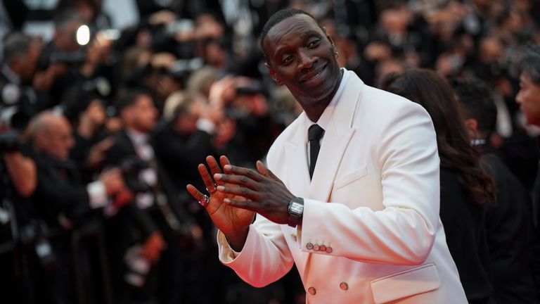 Lupin star Omar Sy opted for a white suit and black tie. Pic: Invision/AP