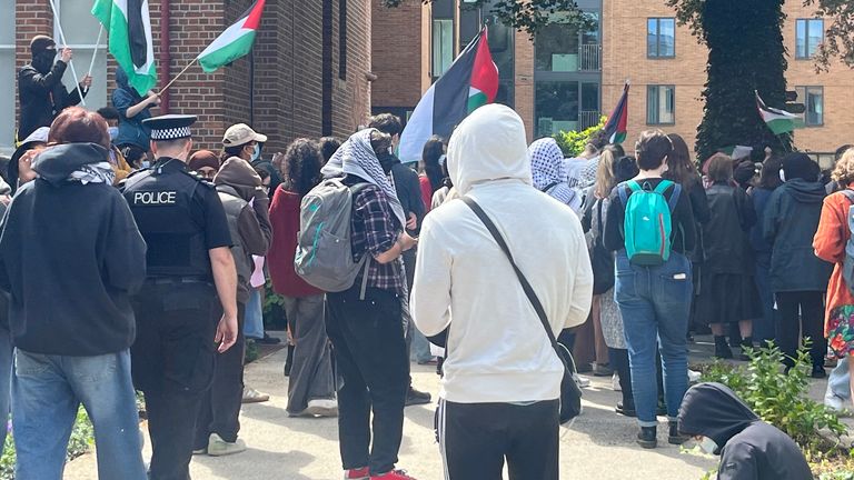Protesters gather outside university building 