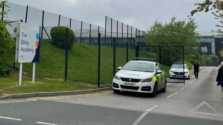 Multiple police vehicles can be seen outside the Birley Academy.